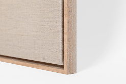 Close-up of a wooden frame with a textured beige interior on a white background