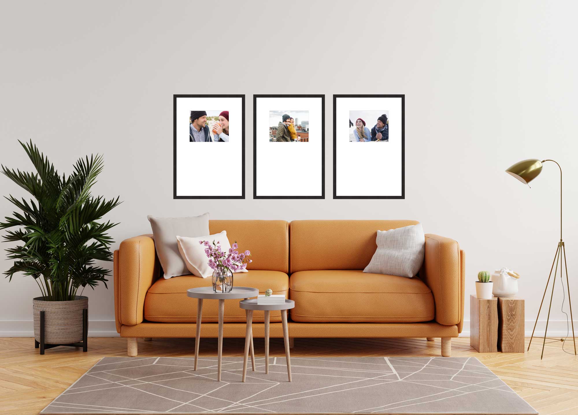 Modern living room with an orange sofa, three framed pictures on the wall, a floor lamp, and a potted plant.
